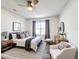 Bright bedroom with neutral tones featuring a padded chair, dresser, and decorative accents at 651 Tortugas St, Haines City, FL 33844