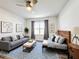 Bright bedroom with a cozy sitting area, decorated with modern artwork, and a blue patterned rug at 651 Tortugas St, Haines City, FL 33844