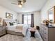 Bright bedroom featuring modern furniture, a dresser, and a padded bench at 651 Tortugas St, Haines City, FL 33844