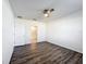 Bedroom with ceiling fan, wood-look floors, closet, and access to ensuite bathroom at 651 Tortugas St, Haines City, FL 33844