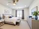 Bright bedroom with a padded bench, dresser, and blue decorative accents at 651 Tortugas St, Haines City, FL 33844