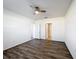Neutral bedroom with ceiling fan, wood-look floors, and access to ensuite bathroom at 651 Tortugas St, Haines City, FL 33844
