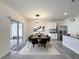 Open dining area with modern lighting, a dark wood table with black chairs, and a view to the outdoor patio at 651 Tortugas St, Haines City, FL 33844