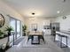 Dining room with a modern light fixture and adjacent kitchen featuring a breakfast bar and stainless steel refrigerator at 651 Tortugas St, Haines City, FL 33844
