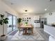 Modern dining area with an adjacent kitchen, featuring an inviting patio view through sliding glass doors at 651 Tortugas St, Haines City, FL 33844