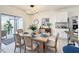 Bright dining area features a wooden table, decorative chandelier, and sliding glass doors to the outdoor patio at 651 Tortugas St, Haines City, FL 33844