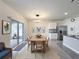 Open-concept dining area with a wooden table, modern lighting, and adjacent kitchen with stainless steel appliances at 651 Tortugas St, Haines City, FL 33844