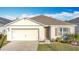 Charming single-story home showcases a well-manicured lawn and an attached two-car garage at 651 Tortugas St, Haines City, FL 33844