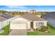 Inviting single-story home with manicured lawn and solar panels for energy efficiency at 651 Tortugas St, Haines City, FL 33844