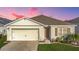Charming single Gathering home with a well-maintained lawn and a two-car garage at 651 Tortugas St, Haines City, FL 33844