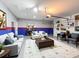 Finished garage boasts stylish seating, shelving, and colorful walls, creating a versatile and inviting space at 651 Tortugas St, Haines City, FL 33844