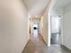 Neutral hallway leads to various rooms, with tiled floors and arched doorways enhancing flow at 651 Tortugas St, Haines City, FL 33844
