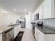 Modern kitchen with white cabinets, stainless steel appliances, and granite countertops at 651 Tortugas St, Haines City, FL 33844