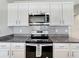 Well-equipped kitchen featuring modern appliances, granite countertops, and ample cabinet space at 651 Tortugas St, Haines City, FL 33844