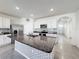 Granite kitchen island with sink and stainless steel appliances at 651 Tortugas St, Haines City, FL 33844