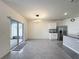 Open-concept kitchen and dining area with tile flooring, modern lighting, and backyard views at 651 Tortugas St, Haines City, FL 33844