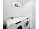 Well-lit laundry room equipped with a Whirlpool washer and dryer set for convenience at 651 Tortugas St, Haines City, FL 33844