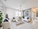Inviting living room with modern white furniture, contrasting black accents, and large windows, creating a stylish and comfortable space at 651 Tortugas St, Haines City, FL 33844