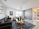 Elegant living room with dark sofa, gold-accented furniture, contemporary art, and a sleek coffee table, offering a sophisticated space at 651 Tortugas St, Haines City, FL 33844