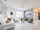 Bright living room features contemporary furnishings, modern art, and sliding glass doors, offering seamless indoor-outdoor living at 651 Tortugas St, Haines City, FL 33844