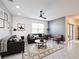 Inviting living room featuring leather sofas, modern decor, a patterned rug, and natural light, creating a cozy and stylish atmosphere at 651 Tortugas St, Haines City, FL 33844