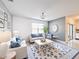 Bright living room boasts comfortable seating, blue accents, patterned rug, and stylish decor, creating an inviting and relaxing space at 651 Tortugas St, Haines City, FL 33844
