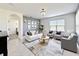 Bright living room with tile floors, stylish furniture, and natural light from a window at 651 Tortugas St, Haines City, FL 33844