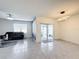 Living room boasts tile flooring, neutral walls, and a comfortable black sofa at 651 Tortugas St, Haines City, FL 33844