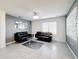 Modern living room with two black sofas and a glass coffee table at 651 Tortugas St, Haines City, FL 33844