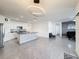 Bright, open floor plan with modern lighting, tile floors, and a spacious island kitchen at 651 Tortugas St, Haines City, FL 33844