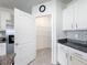 Well-organized pantry offers ample shelving and storage space, adjacent to stainless steel refrigerator at 651 Tortugas St, Haines City, FL 33844