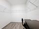 The walk-in closet is equipped with overhead shelving and a desk with an office chair at 651 Tortugas St, Haines City, FL 33844