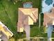 Aerial view of beautiful house with manicured lawn, brick driveway, and large roof at 6533 Cartmel Ln, Windermere, FL 34786