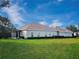 Expansive backyard features a well-maintained lawn, mature trees and privacy hedge at 6533 Cartmel Ln, Windermere, FL 34786