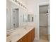Bright bathroom featuring double sinks, wood cabinets, and a large mirror with vanity lighting at 6533 Cartmel Ln, Windermere, FL 34786