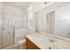 Bathroom showcasing a glass shower, single sink vanity with marble top, and neutral tile flooring at 6533 Cartmel Ln, Windermere, FL 34786