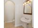 Charming powder room with pedestal sink and ornate mirror at 6533 Cartmel Ln, Windermere, FL 34786