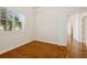 Bright bedroom with hardwood floors, large window, and an open doorway to additional living space at 6533 Cartmel Ln, Windermere, FL 34786