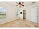 Cozy bedroom featuring tile floors, a ceiling fan, and a closet for ample storage at 6533 Cartmel Ln, Windermere, FL 34786