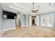 Large bedroom boasting travertine floors, tray ceilings, and access to other rooms in the house at 6533 Cartmel Ln, Windermere, FL 34786