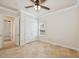 Bedroom featuring travertine floors, a ceiling fan, and a closet for ample storage at 6533 Cartmel Ln, Windermere, FL 34786