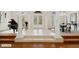 Grand foyer featuring a piano, tile flooring, arched doorways, and ample natural light at 6533 Cartmel Ln, Windermere, FL 34786