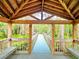 Beautiful view of a gazebo surrounded by lush greenery and a wooden pathway at 6533 Cartmel Ln, Windermere, FL 34786
