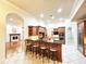 Open kitchen with wooden cabinets and breakfast bar at 6533 Cartmel Ln, Windermere, FL 34786