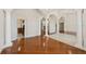 Spacious living room with hardwood floors, arched doorways, and a glimpse of the kitchen at 6533 Cartmel Ln, Windermere, FL 34786