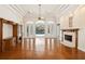 Spacious living room with hardwood floors, fireplace, built-in shelving and french doors to the pool area at 6533 Cartmel Ln, Windermere, FL 34786