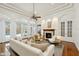 Bright living room with fireplace, hardwood floors, coffered ceilings, and pool views at 6533 Cartmel Ln, Windermere, FL 34786
