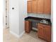 Mud room with wooden cabinets and granite countertop at 6533 Cartmel Ln, Windermere, FL 34786