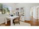 Home office with built-in shelves, natural light and wood flooring at 6533 Cartmel Ln, Windermere, FL 34786