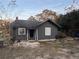 Dark gray house with a small porch and yard at 310 Lake Ave, Dundee, FL 33838
